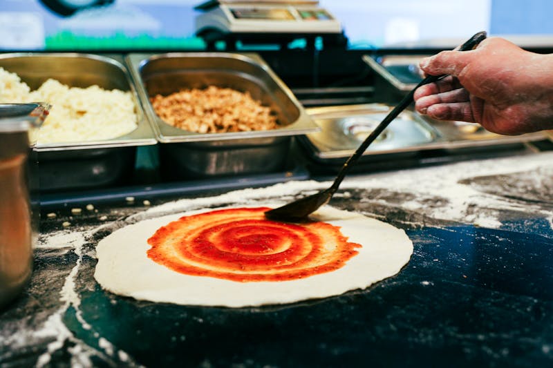 Via 313 kitchen team preparing fresh Detroit-style pizza